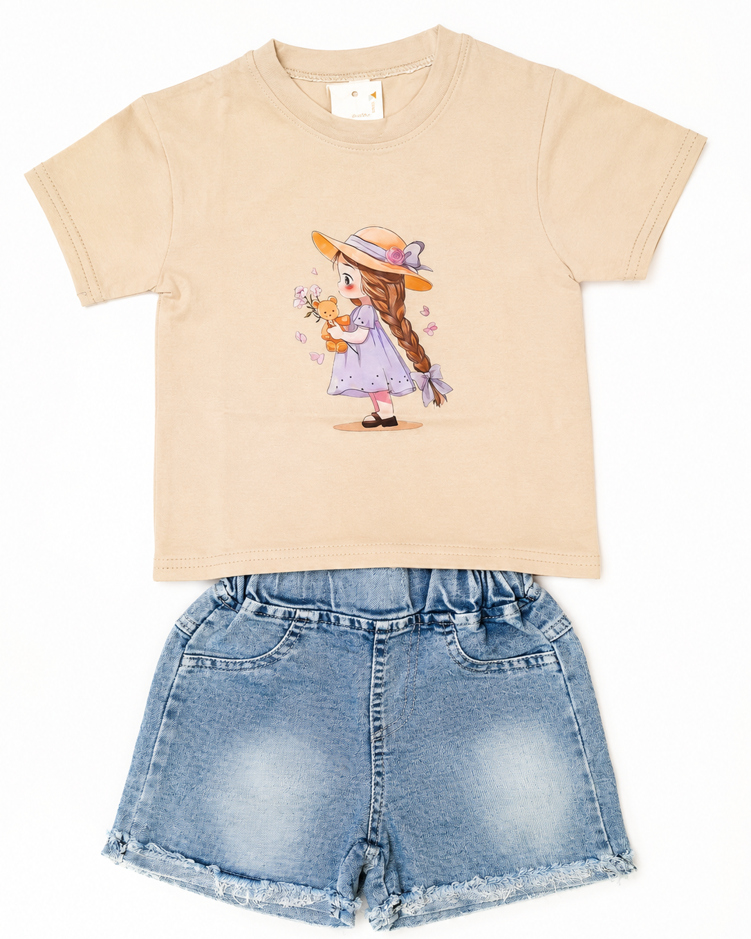 A children's two-piece outfit featuring a beige short-sleeve t-shirt with a cartoon girl graphic and light blue denim shorts, 