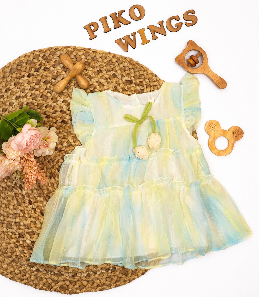 A baby girl's tiered ruffled dress in a pastel yellow and light blue tie-dye pattern
