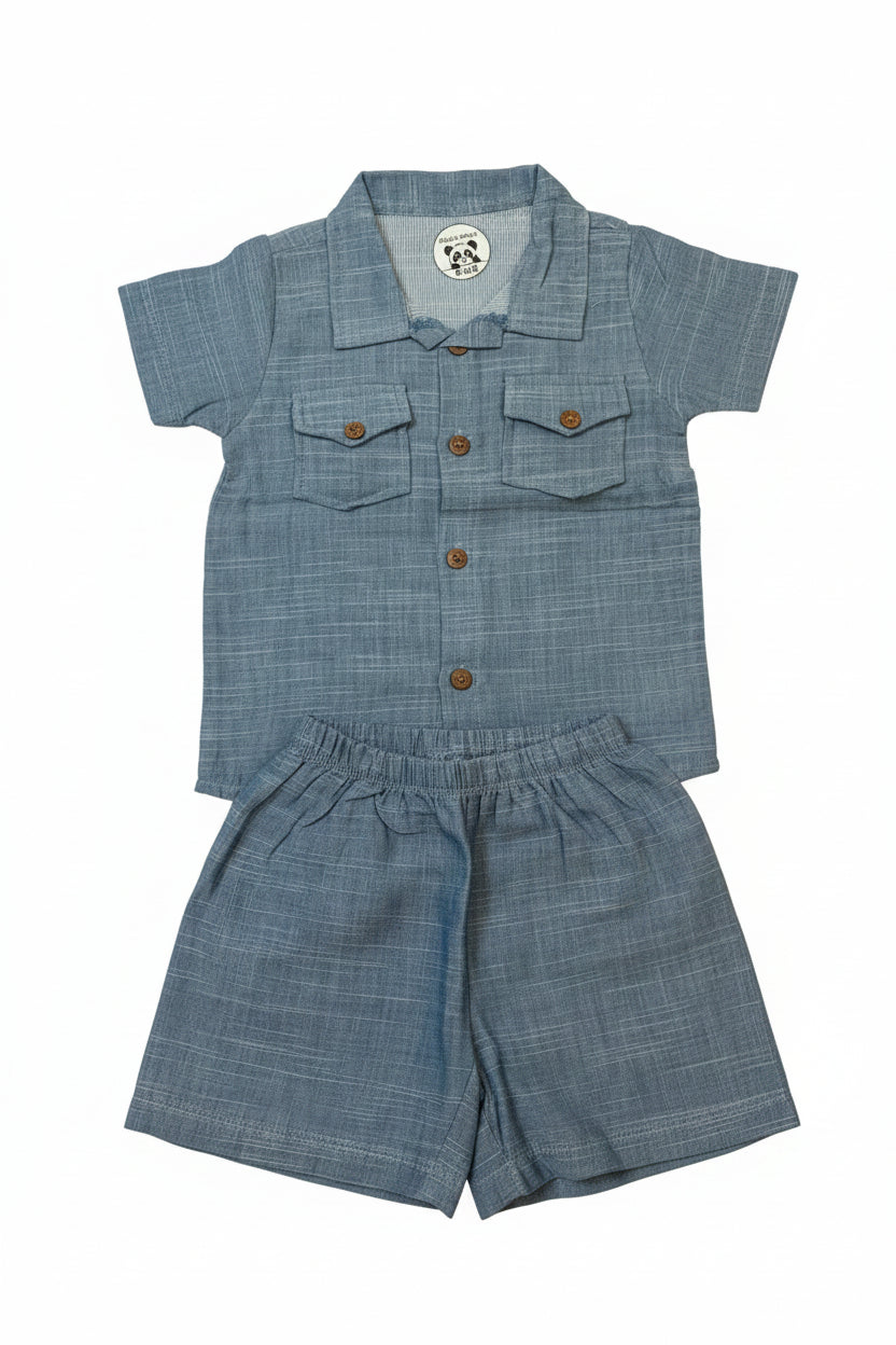 A two-piece baby outfit set consisting of a short-sleeve button-up shirt and matching shorts in a textured blue-gray fabric. The shirt features two chest pockets with button closures and a collar.