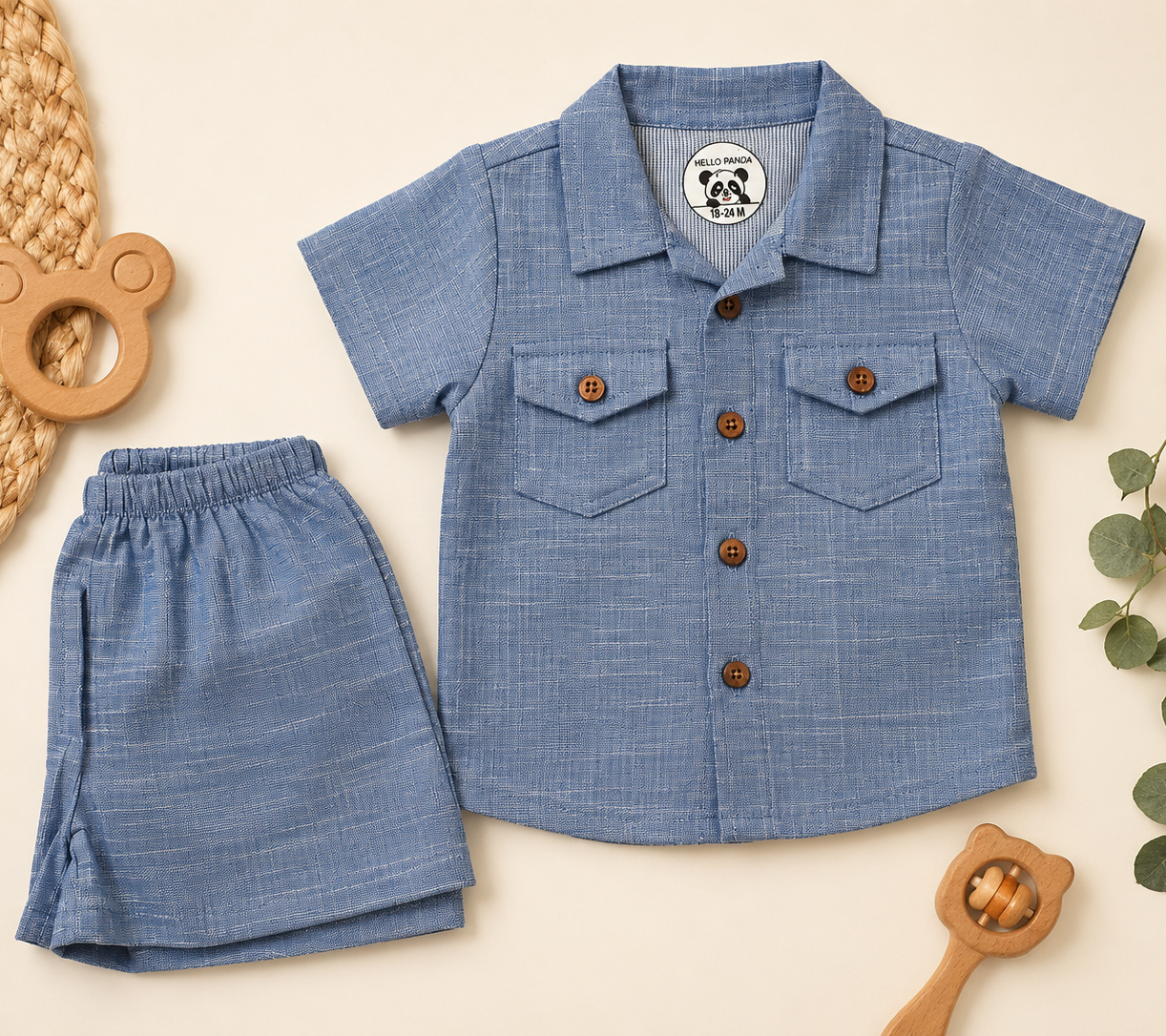 A baby boy's two-piece linen shirt and shorts set in a dusty blue color,